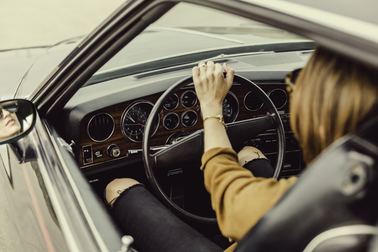 Woman driving a gray car