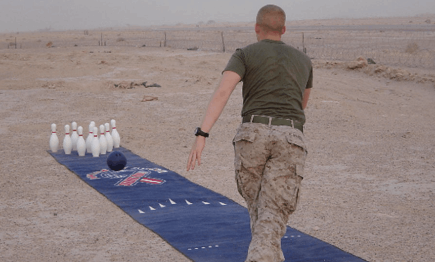 solider bowling in the sand