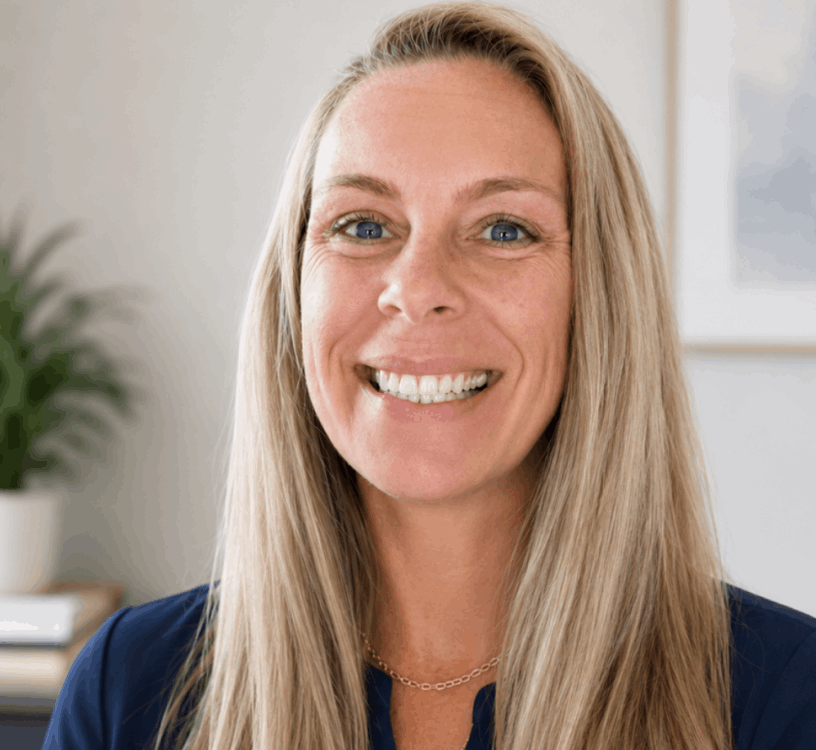 Erica smiling wearing a blue shirt in an office background